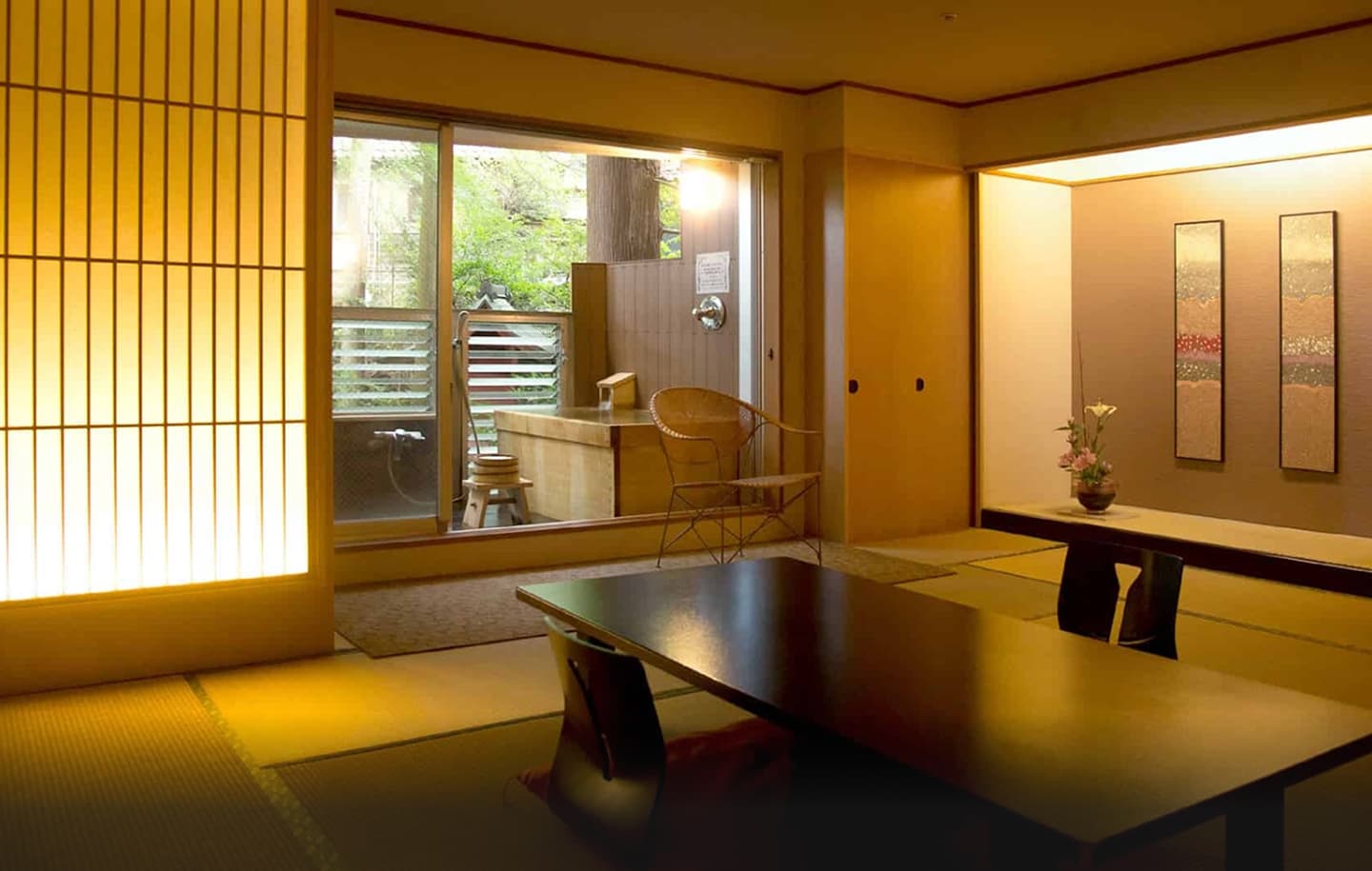 鮮やかな赤色の壁が印象的な、旅館のツインベッドルームの全景。手前には白い清潔な布団がかけられた二つのベッドが並び、それぞれに可愛らしい柄の掛け布団がアクセントとして置かれている。